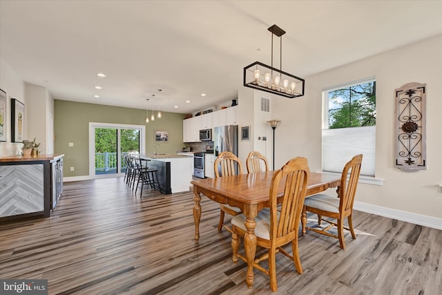 10031 Whitaker Way, Parkville, MD 21234 - dining room featuring visible vents, wood finished floors, and a healthy amount of sunlight