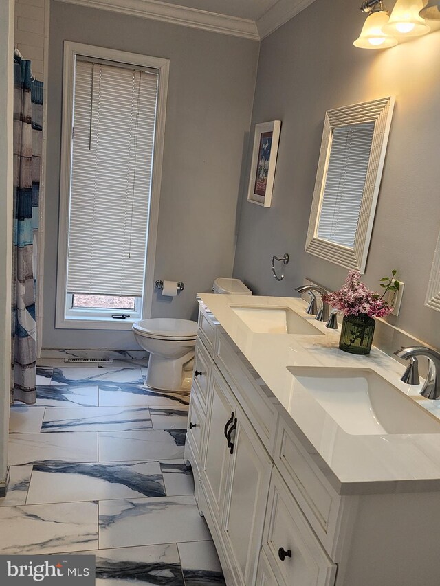 full bathroom with a sink, ornamental molding, toilet, and marble finish floor