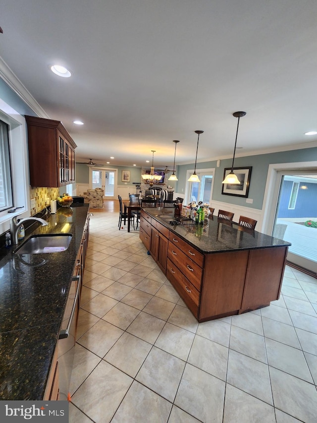 kitchen with recessed lighting, glass insert cabinets, a sink, and crown molding