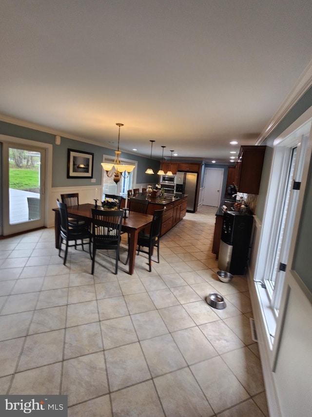 dining space featuring an inviting chandelier, recessed lighting, light tile patterned floors, and crown molding