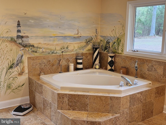full bathroom featuring a bath, baseboards, and a wealth of natural light