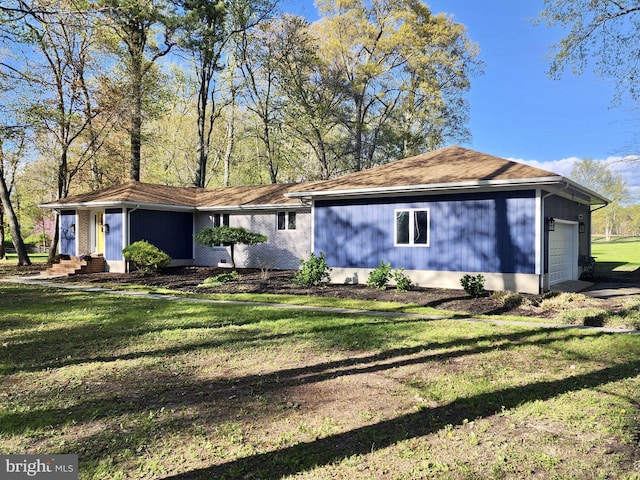 ranch-style house with entry steps, a front lawn, and a garage