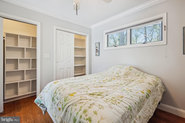 bedroom with baseboards, ornamental molding, and wood finished floors