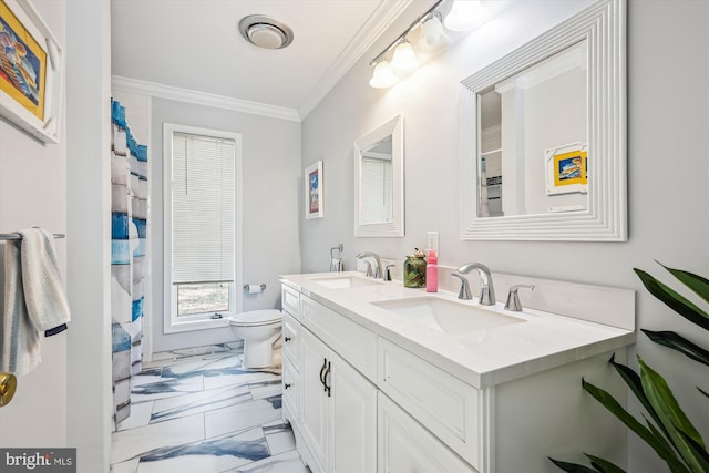 bathroom with marble finish floor, toilet, ornamental molding, and a sink