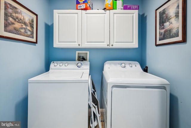 laundry area featuring cabinet space and washing machine and clothes dryer