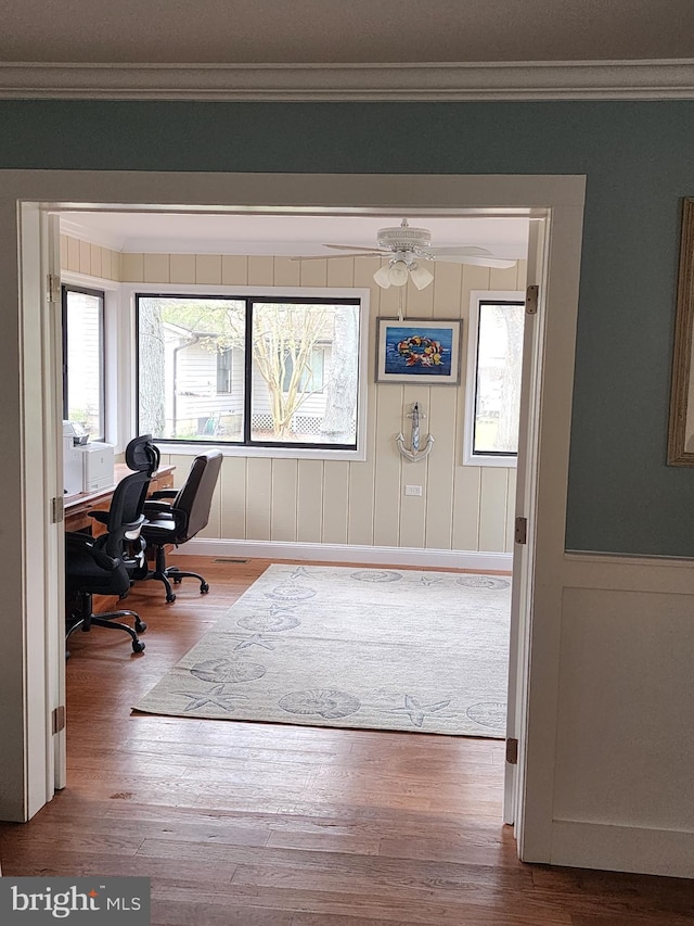 home office with crown molding and wood finished floors