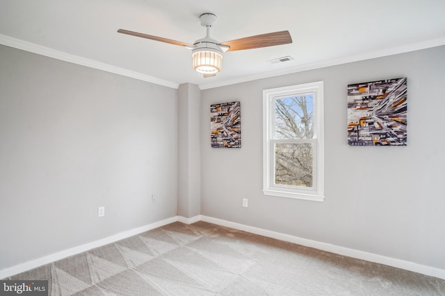 unfurnished room featuring baseboards, light carpet, crown molding, visible vents, and ceiling fan