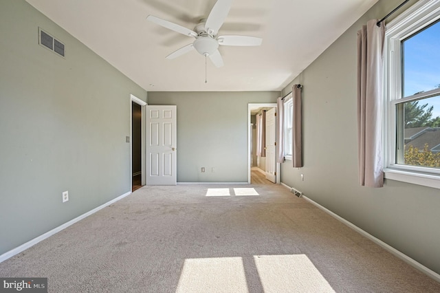 unfurnished bedroom with carpet floors, baseboards, and visible vents