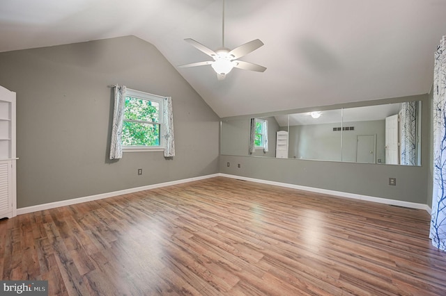 additional living space featuring visible vents, a ceiling fan, plenty of natural light, and vaulted ceiling