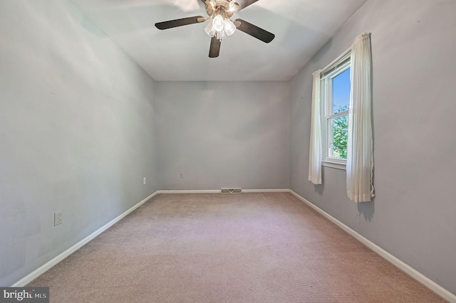 unfurnished room featuring visible vents, carpet flooring, baseboards, and ceiling fan