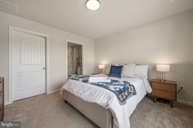 carpeted bedroom with baseboards and visible vents