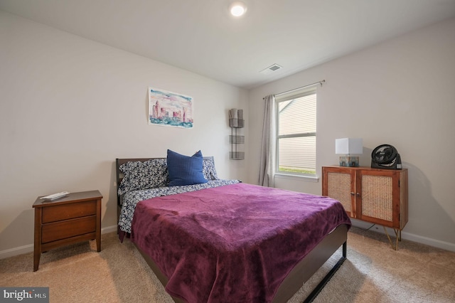 bedroom with carpet floors, visible vents, and baseboards