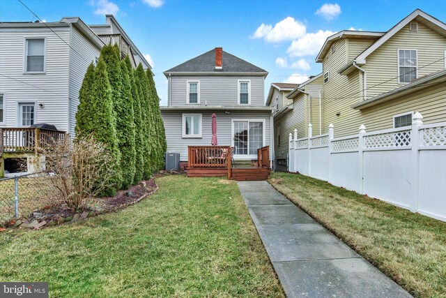 1205 Bridge St, New Cumberland, PA 17070 - back of house with a yard, central AC, a deck, and a fenced backyard