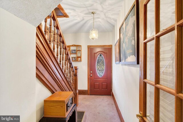 1205 Bridge St, New Cumberland, PA 17070 - foyer entrance with stairway, carpet flooring, baseboards, a textured ceiling, and a notable chandelier
