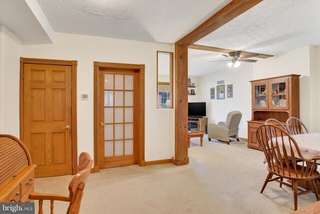 1205 Bridge St, New Cumberland, PA 17070 - dining room featuring carpet floors, a textured ceiling, a ceiling fan, and beam ceiling