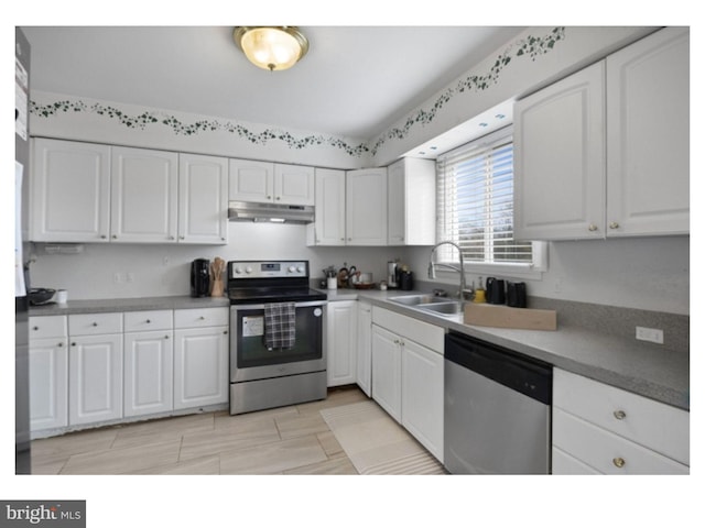 kitchen featuring white cabinetry, under cabinet range hood, and stainless steel appliances