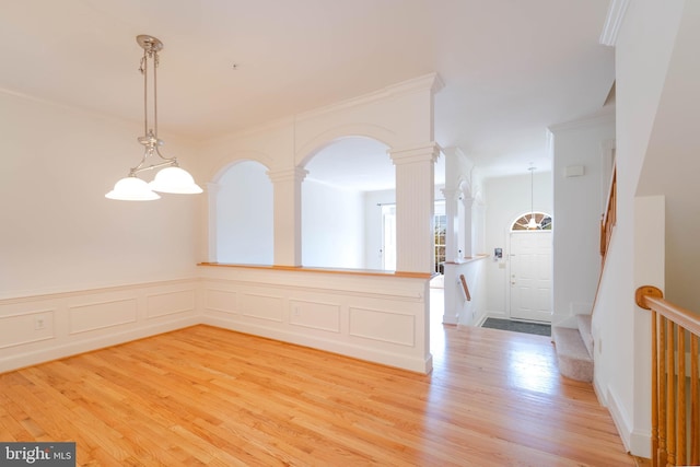 6038 Kelsey Ct, Falls Church, VA 22044 - interior space with crown molding, a decorative wall, decorative columns, arched walkways, and light wood finished floors