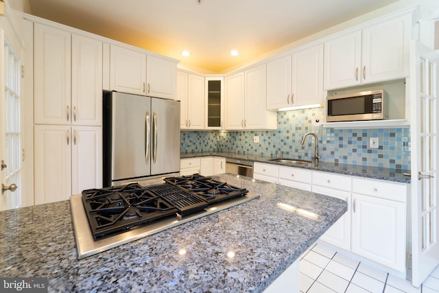6038 Kelsey Ct, Falls Church, VA 22044 - kitchen with light tile patterned floors, tasteful backsplash, white cabinets, a sink, and stainless steel appliances
