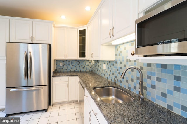 6038 Kelsey Ct, Falls Church, VA 22044 - kitchen featuring dark stone counters, tasteful backsplash, white cabinetry, a sink, and stainless steel appliances