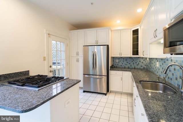 6038 Kelsey Ct, Falls Church, VA 22044 - kitchen featuring light tile patterned floors, a sink, white cabinetry, stainless steel appliances, and decorative backsplash