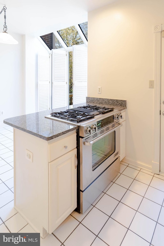 6038 Kelsey Ct, Falls Church, VA 22044 - kitchen with stone counters, white cabinets, light tile patterned flooring, stainless steel stove, and decorative light fixtures