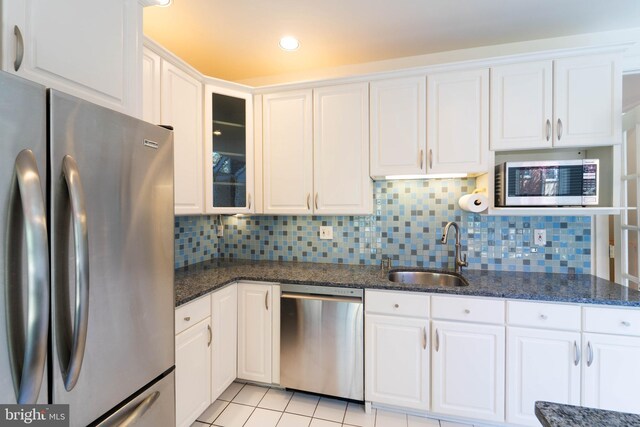6038 Kelsey Ct, Falls Church, VA 22044 - kitchen featuring stainless steel appliances, white cabinetry, a sink, and light tile patterned flooring