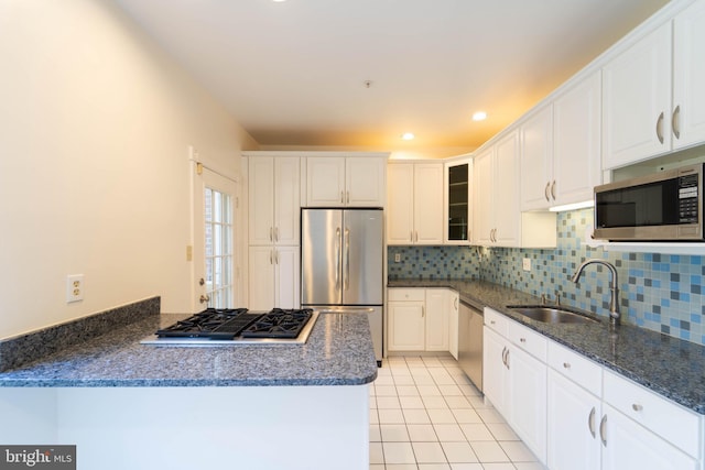 6038 Kelsey Ct, Falls Church, VA 22044 - kitchen with white cabinets, a sink, appliances with stainless steel finishes, backsplash, and light tile patterned flooring