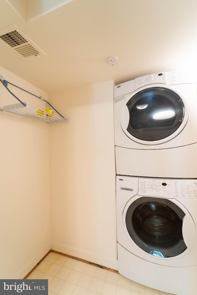 6038 Kelsey Ct, Falls Church, VA 22044 - laundry room with stacked washing maching and dryer, laundry area, baseboards, and visible vents