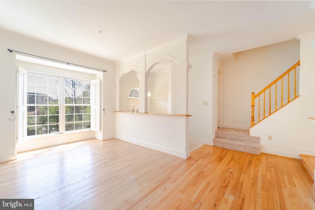 6038 Kelsey Ct, Falls Church, VA 22044 - unfurnished living room with stairs, ornate columns, baseboards, and wood finished floors