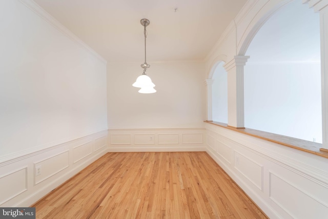 6038 Kelsey Ct, Falls Church, VA 22044 - unfurnished dining area with crown molding, a decorative wall, decorative columns, light wood-style flooring, and arched walkways