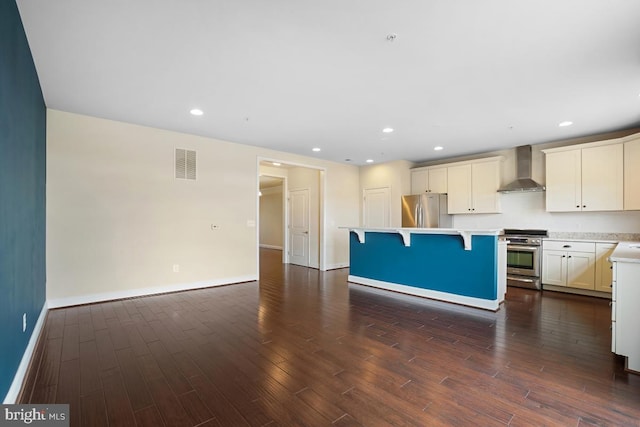 5919-2 Logans Way Unit 2, Ellicott City, MD 21043 - kitchen featuring stainless steel appliances, wall chimney range hood, dark wood finished floors, a kitchen island, and a breakfast bar