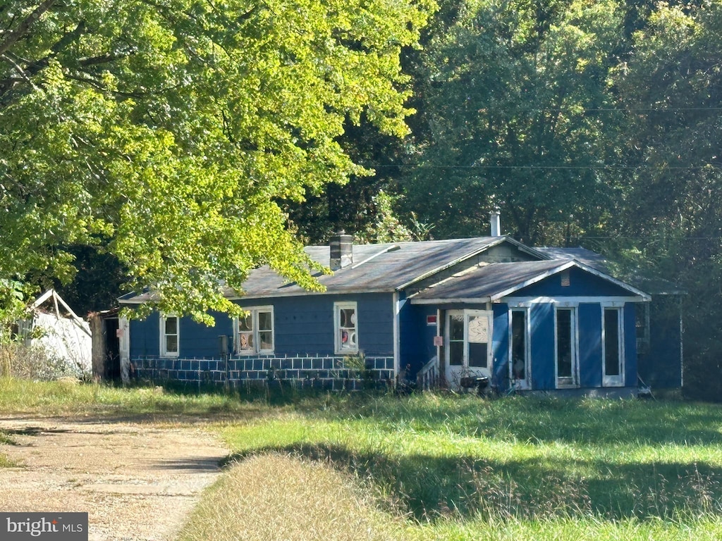 view of front of home featuring a chimney