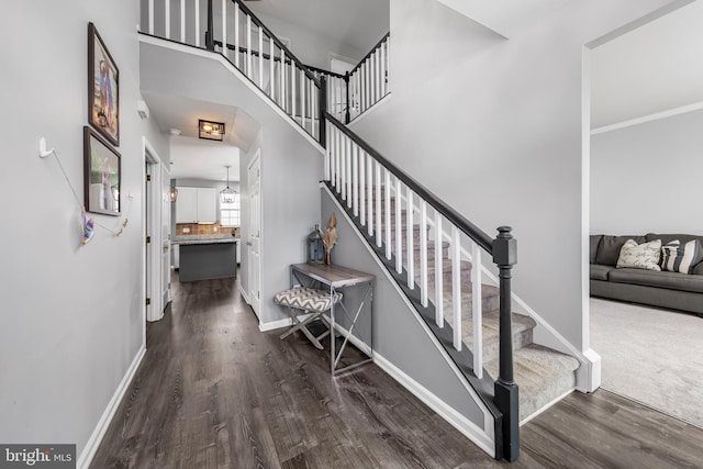 stairway featuring wood finished floors and baseboards