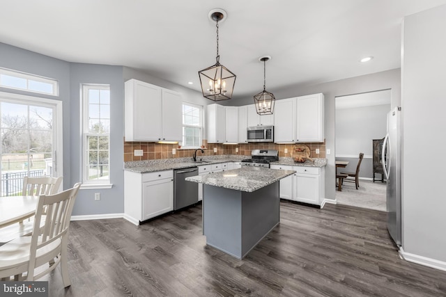 kitchen featuring appliances with stainless steel finishes, baseboards, decorative backsplash, white cabinets, and recessed lighting