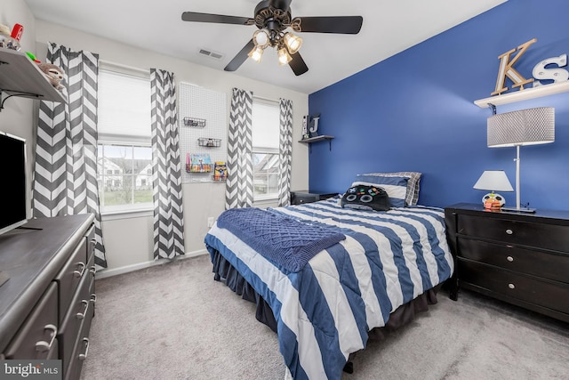 bedroom featuring multiple windows, carpet flooring, a ceiling fan, and baseboards
