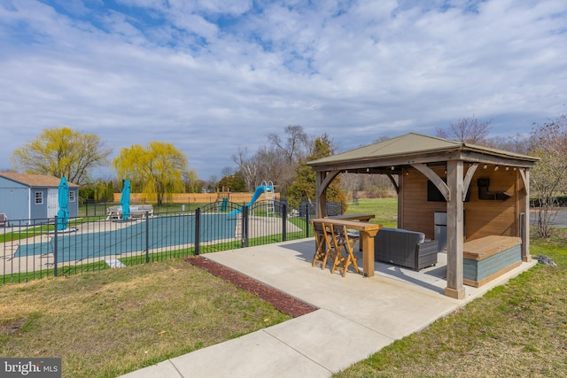 view of home's community featuring a patio area, a gazebo, a swimming pool, and an outdoor structure