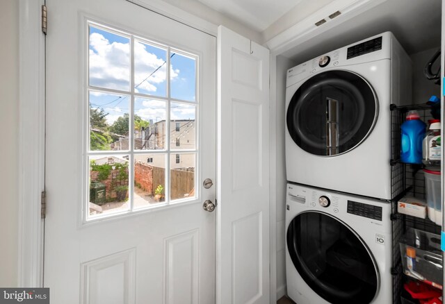 laundry room with stacked washer and clothes dryer