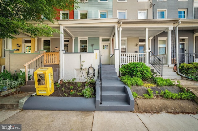 view of exterior entry with a porch