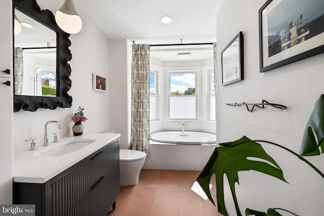 bathroom featuring a relaxing tiled tub, toilet, tile patterned flooring, vanity, and recessed lighting