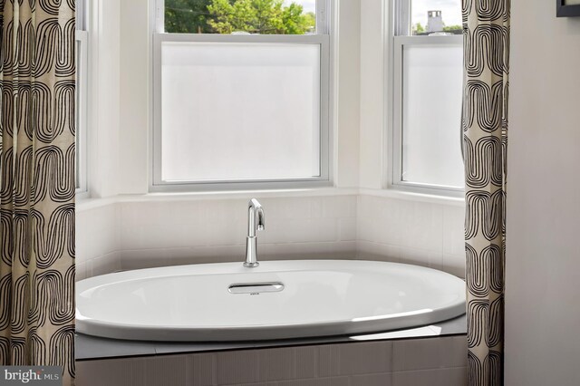 bathroom with tiled tub