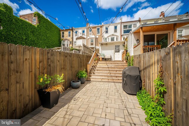 view of patio featuring a fenced backyard, a residential view, and area for grilling
