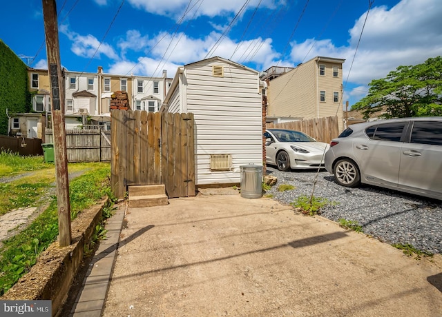 view of property exterior with fence and a residential view