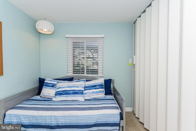 11500 Coastal Hwy Unit 317, Ocean City, MD 21842 - bedroom with light wood-type flooring and a textured ceiling