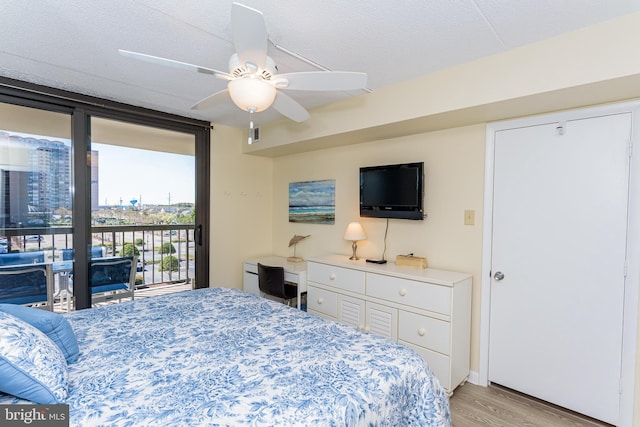 11500 Coastal Hwy Unit 317, Ocean City, MD 21842 - bedroom with floor to ceiling windows, a ceiling fan, light wood-style floors, a textured ceiling, and access to exterior