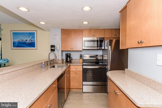 11500 Coastal Hwy Unit 317, Ocean City, MD 21842 - kitchen with a sink, appliances with stainless steel finishes, light wood-style floors, a textured ceiling, and recessed lighting