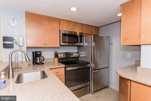 11500 Coastal Hwy Unit 317, Ocean City, MD 21842 - kitchen featuring recessed lighting, a textured ceiling, appliances with stainless steel finishes, light wood finished floors, and a sink