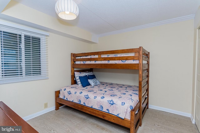 11500 Coastal Hwy Unit 317, Ocean City, MD 21842 - bedroom featuring baseboards, light wood-type flooring, and ornamental molding