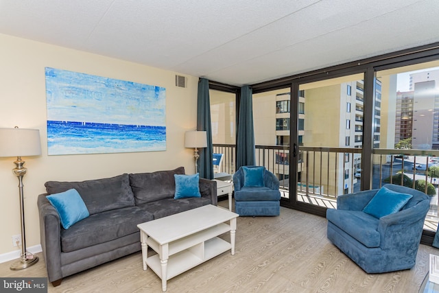 11500 Coastal Hwy Unit 317, Ocean City, MD 21842 - living area with visible vents, baseboards, wood finished floors, and floor to ceiling windows