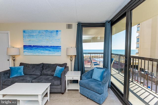 11500 Coastal Hwy Unit 317, Ocean City, MD 21842 - living area with a water view, visible vents, a wall of windows, and light wood finished floors