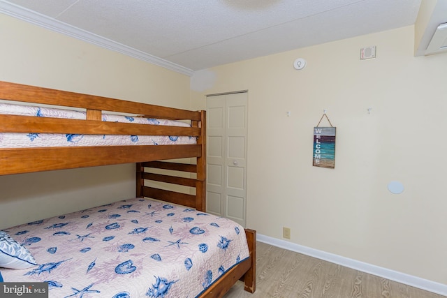 11500 Coastal Hwy Unit 317, Ocean City, MD 21842 - bedroom featuring ornamental molding, visible vents, baseboards, and wood finished floors